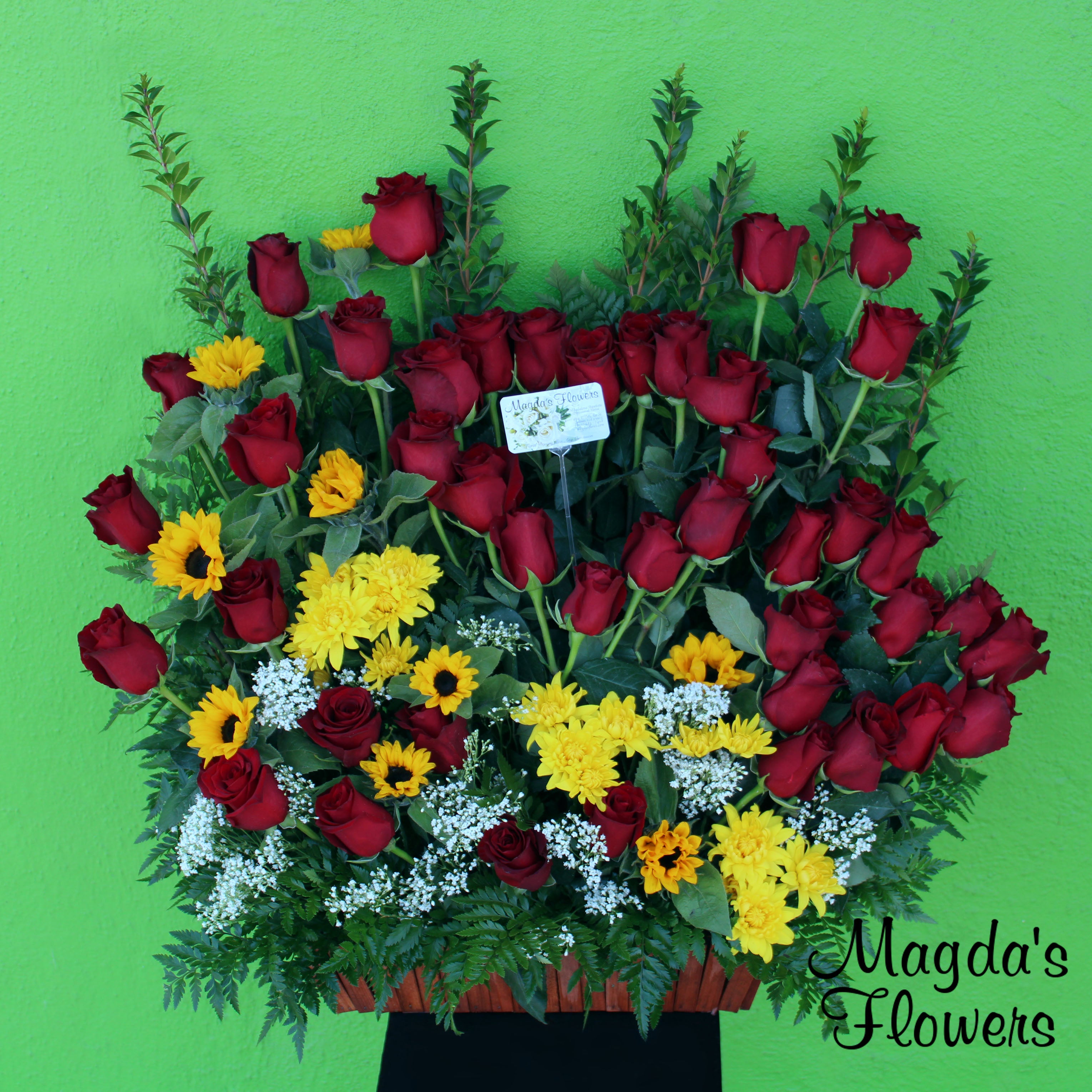 Loving Hearts - ﻿﻿This heartwarming floral basket is the perfect way to express your love and affection towards your heart's companion. It features two heart-shaped arrangements of red roses, surrounded by carnation, sunflowers, myrtle stems and even more red roses. The greenery adds a touch of freshness to this elegant basket that is ideal for expressing your love on Valentine's Day, Anniversaries, or any special occasion that calls for a touch of romance. 