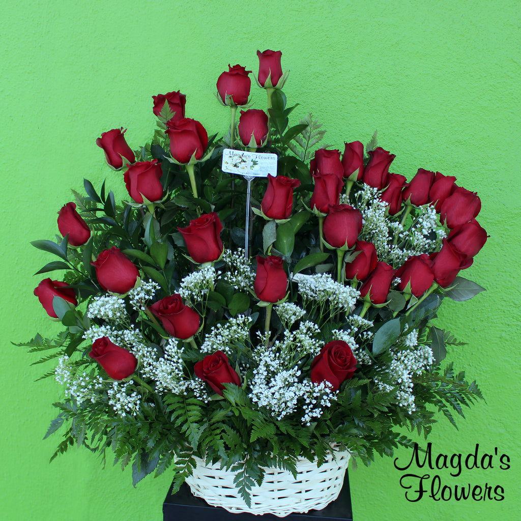 Loves Embrace This elegant floral arrangement is the perfect way to express your love and affection. It features a charming heart arrangement of deeo red roses, surrounded by lush greenery on a lovely basket. This combination creates a captivating design that will make an impression on your special someone. 